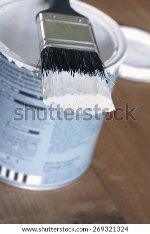 Painting and decorating shallow focus view of a pot of white paint and brush