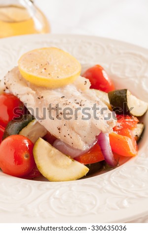Fish Provencal a French seafood dish of roasted vegetables and white fish fillet