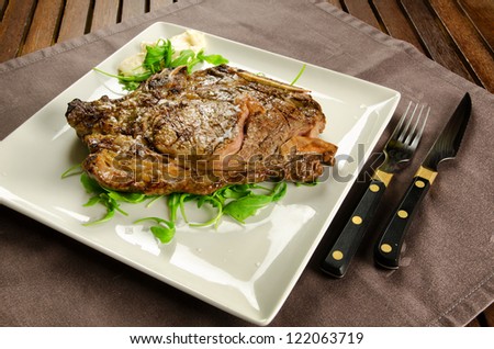 Grilled sirloin beef steak on white plate, BBQ meat