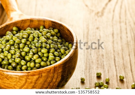 Green soybeans on wooden background, biologic agriculture