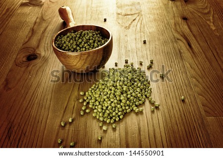 Green soybeans on wooden background, biologic agriculture