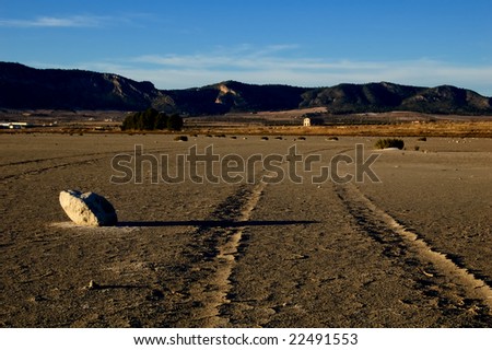 Dry salt lake - desert landscape, trace of tires detail - global warming, climate change - Laguna de Salinas (Spain)