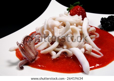 Recipe: Squid with caviar and red strawberry sauce, withe dish on black background