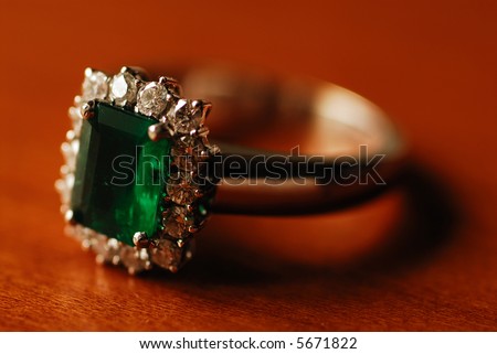a closer view on a ring mounted by emerald and diamond