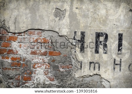 vintage exterior rendered brick wall with fragments of letters background