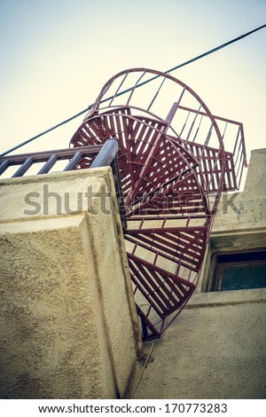 red metal spiral stair shoot from a worm\'s eye view.
