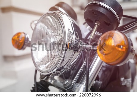 close up of a motorcycle headlight with blinker light