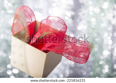 open christmas gift box with red ribbon  in it