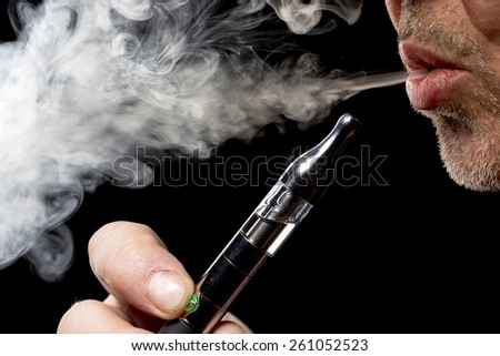 close up portrait of a man smoking an e-cigarette close up portrait of a man smoking an e-cigarette