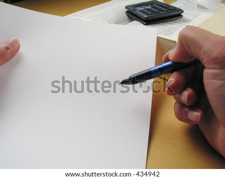 Hands holding blank paper and pen pointing at some spot