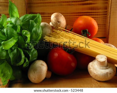 Warm still life of pasta and the need ingredients to cook a delicious meal!