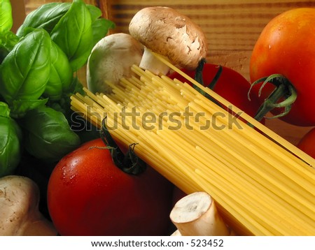 Warm close-up of still life of pasta and the need ingredients to cook a delicious meal!
