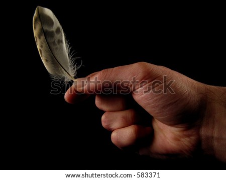 Hand holding a feather (black background)