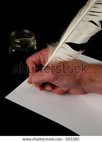 Hand holding a feather writing on white paper with ink (black background)