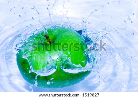 Green apple splashing in water, lovely colour and great reflections on every single drop. Very sharp, you can see the texture of the fruit (taken with F9).