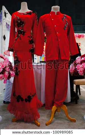 LUMUT, MALAYSIA - APR 22: A pair of Malay bridal dress display during Perak Bridal Carnival at Marina Island Hall on Apr 22, 2012 in Lumut Perak, Malaysia.