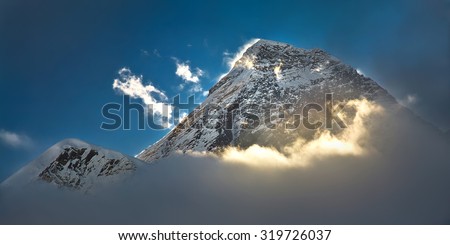The peak of the highest mountain in the world - Mt. Everest in the light of the first sunrays.