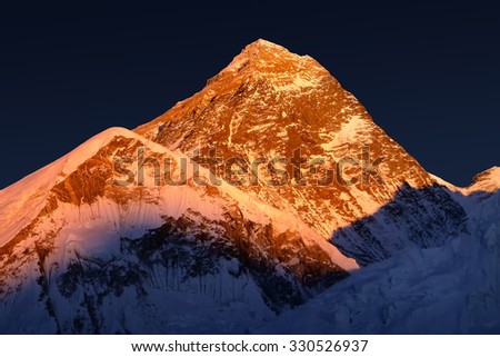 The peak of the highest mountain in the world - Mt. Everest at the sunset.