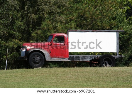 old truck with a blank sign on the back
