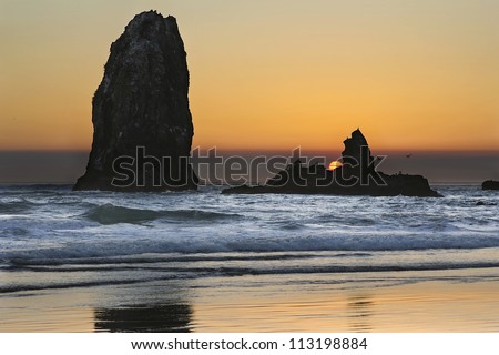 Sunset Over Haystack Needles Rock on Cannon Beach Oregon Coast with Waves and Seabirds