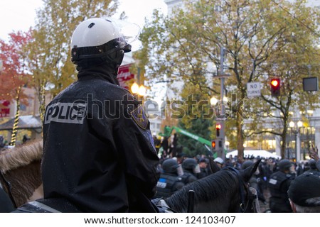 PORTLAND, OREGON - NOV 17: Mounted Police Watching over protestors in Downtown Portland, Oregon during a Occupy Portland protest on the first anniversary of Occupy Wall Street November 17, 2011