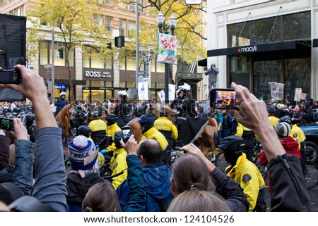 PORTLAND, OREGON - NOV 17: Spectators taking pictures with camera phones of Police in Riot Gear in Downtown Portland, Oregon during a Occupy Portland Protest November 17, 2011