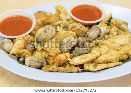 Southeast Asian Fried Baby Oyster Omelette Oh Chien with Chili Sauce Closeup