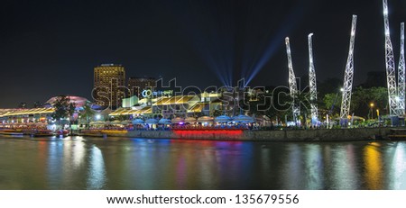 SINGAPORE, SINGAPORE - MAR 13 : Nightlife at Clarke Quay Along Singapore River Panorama on Mar 13, 2013. A popular tourist attraction in Singapore with boat rides restaurants night clubs and shopping