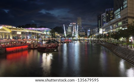 SINGAPORE, SINGAPORE - MAR 13 : Nightlife at Clarke Quay Along Singapore River Panorama Blue Hour on Mar 13, 2013. Popular tourist attraction in Singapore with boat rides restaurants clubs and shops