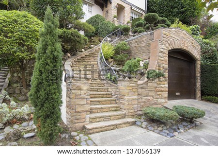 Stone Veneer Facade on Home Exterior with Manicured Front Entrance Yard Landscape