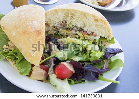 Tuna Salad Sandwich with Ciabatta Bread and Leafy Mixed Green Salad with Tomatoes