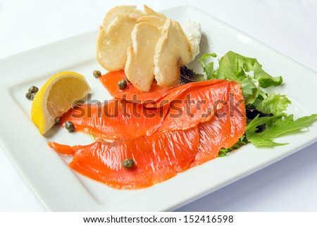 Smoked Salmon with Capers Lemon Salad and Bread on White Square Plate