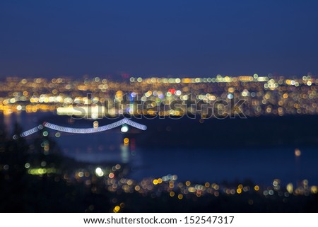 Vancouver BC Canada Cityscape with Stanley Park and Lions Gate Bridge at Evening Blue Hour Defocused Blurred Background