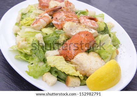 Caesar Salad with Prawns Salmon White Cod Fish Croutons Lemon and Cracked Black Pepper
