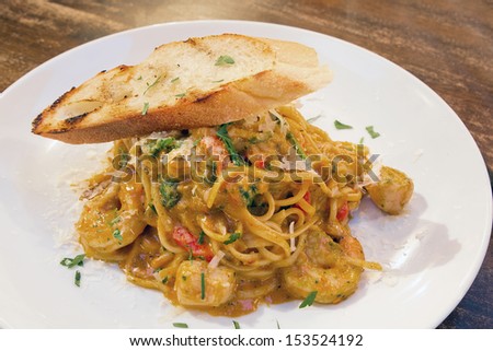 Seafood Spaghetti Pasta Cooked in Tomato Cream Sauce with Prawns Scallops White Fish Basil Bell Peppers and Bread