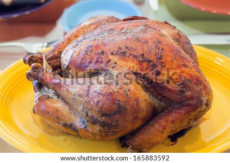 Cooked Roast Turkey on Yellow Platter for Thanksgiving Dinner