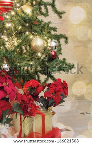 Christmas Tree Decoration with Bokeh Lights Sparkles Ornaments Ribbons Poinsettia and Presents Under the Tree