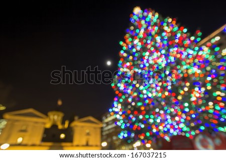 Christmas Holiday Tree with Moon at Pioneer Courthouse Square in Portland Oregon Downtown with Blur Defocused Bokeh Colorful Lights at Night