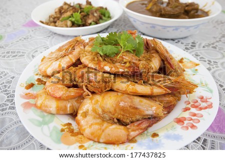 Cooked Jumbo Large Prawns with Garlic Sauce Garnished with Cilantro and other Southeast Asian Dishes