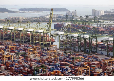 SINGAPORE, SINGAPORE - JAN 30, 2014: Port of Singapore with Container Ships Loading and Unloading Containers at shipyard. Singapore is the second busiest port in the world in terms of tonnage.