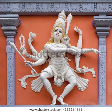 Nataraj Dancing Form of Lord Shiva Hindu God Orange and White Statue on Temple Exterior Wall Relief