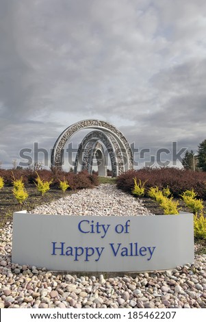 HAPPY VALLEY, OREGON - MARCH 30, 2014: City of Happy Valley Sign with Outdoor Steel and Stone Art Sculpture at Entrance to th city. Happy Valley is in Clackamas County  Oregon and Incorporated 1965.