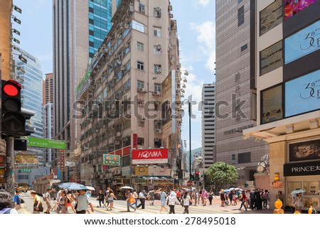 TIMES SQUARE, HONG KONG - MAY 30, 2014: Busy intersection scene of Hong Kong Times Square. Hong Kong Times Square is a major tourist attraction with many shops and restaurants.