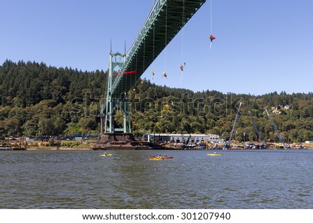 PORTLAND, OREGON - JULY 29, 2015: Greenpeace USA activists rappelled off St Johns Bridge in Portland OR in protest preventing Shell Oil Icebreaker Vessel leaving for oil drilling in the Artic