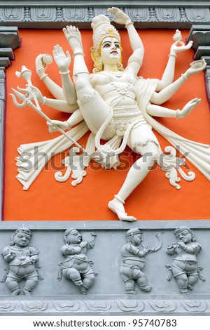 Hindu Goddess with Many Arms  Holding Weapons Statue on Wall of Sri Senpaga Vinayagar Temple