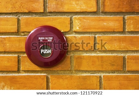 Fire break glass alarm switch  on brick wall