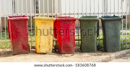 colourful dustbins in the public area of a port