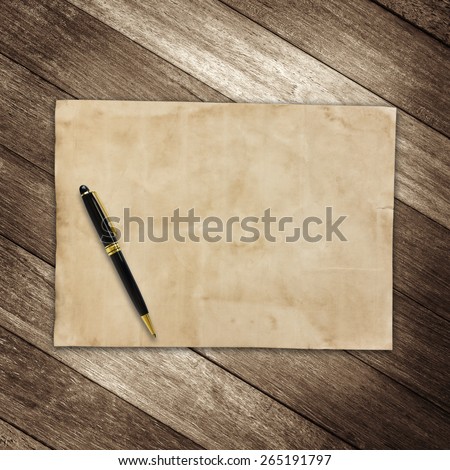 old brown paper and pen on wooden wall background for texture