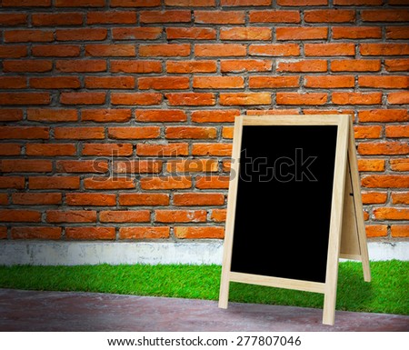 tripod blackboard in interior room with molder brick wall blackground