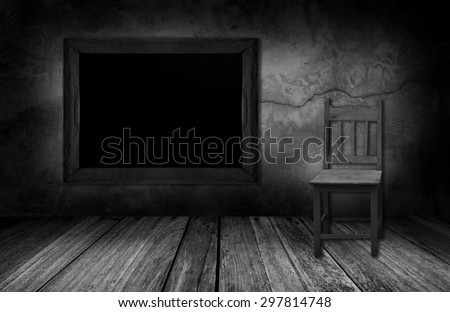 blackboard and wood chair in interior room with gray stone wall.